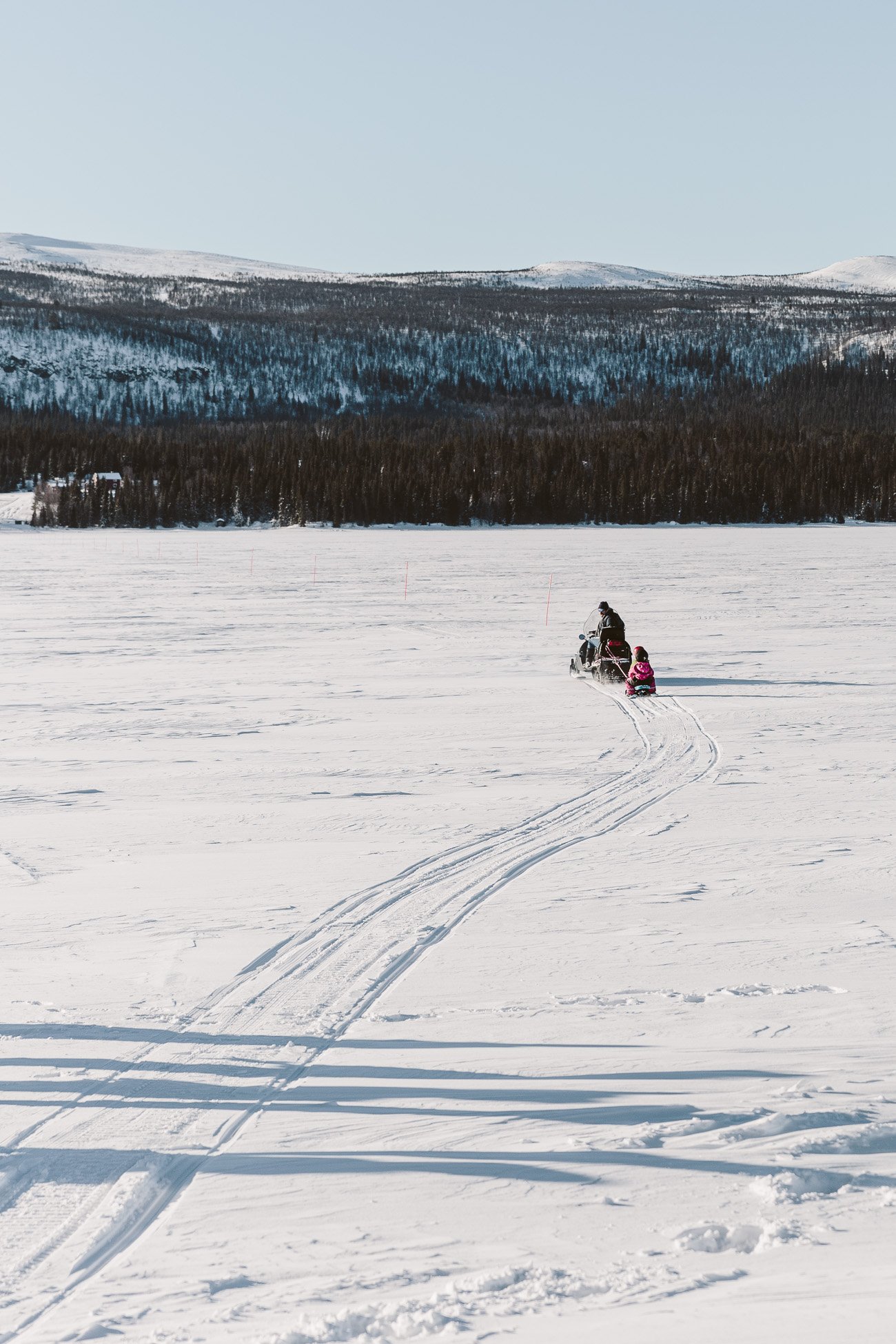 Snowmobile ride over a frozen lake in Swedish Lapland